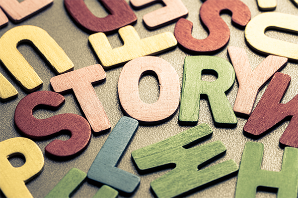 Multicolored wooden letters including ones that spell out the word "story"