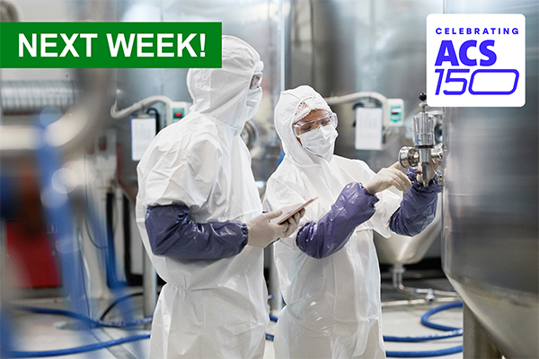 2 workers in PPE inspecting a reactor in a pharmaceutical manufacturing plant